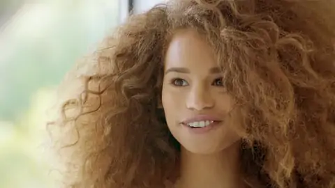 Teenager dark-hued with wavy hair is railing a thick salami on the sofa