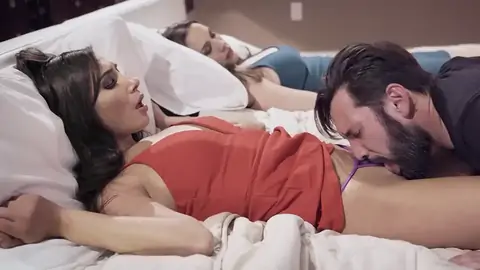 Spouse munching youthfull honey's beaver next to sleeping wifey