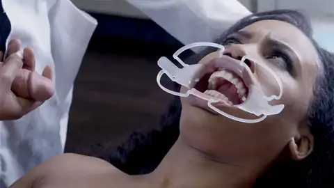 Medic boinks face of astonished patient in the medical center